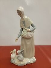 NAO / LLADRO - PEASANT WOMAN FEEDING TWO RABBITS. picture