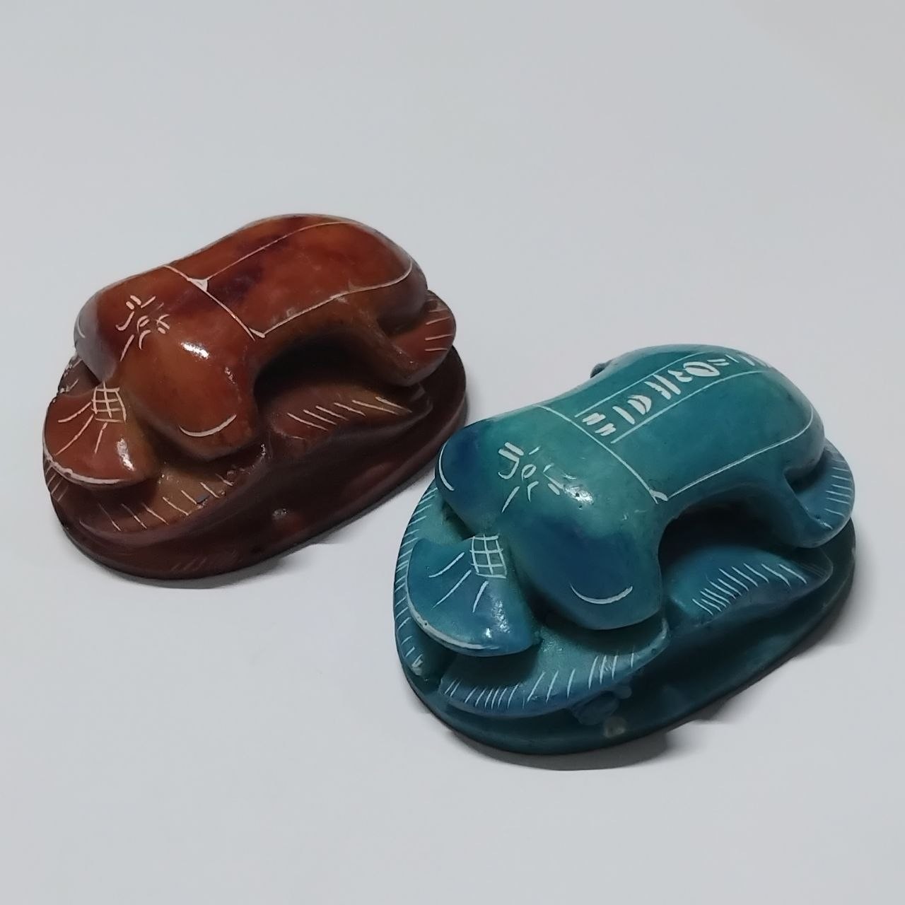 Handcrafted scarab beetle carvings blue and brown stone ancient Egyptian style Handcrafted scarab beetle carvings blue and brown stone ancient Egyptian style