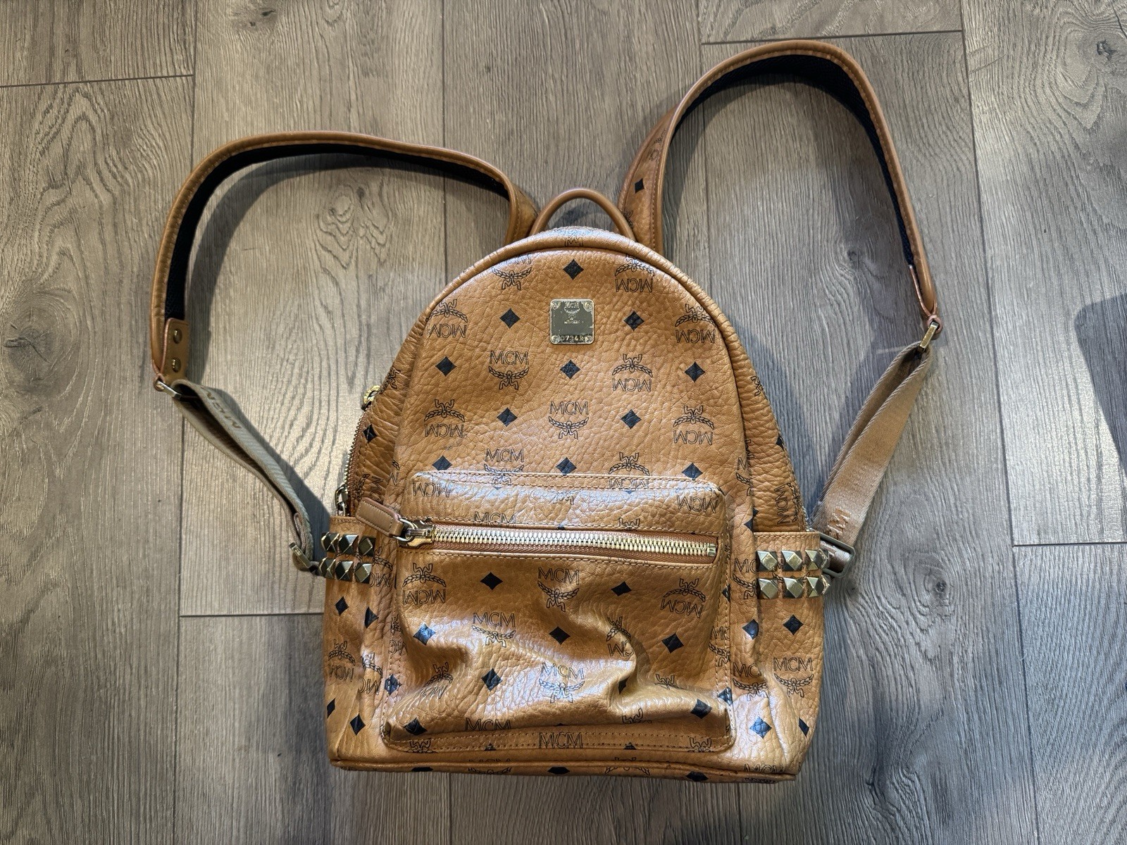 MCM Stark Visetos Backpack Cognac Brown Studded Logo Leather Trim Black Inside MCM Stark Visetos Backpack Cognac Brown Studded Logo Leather Trim Black Inside