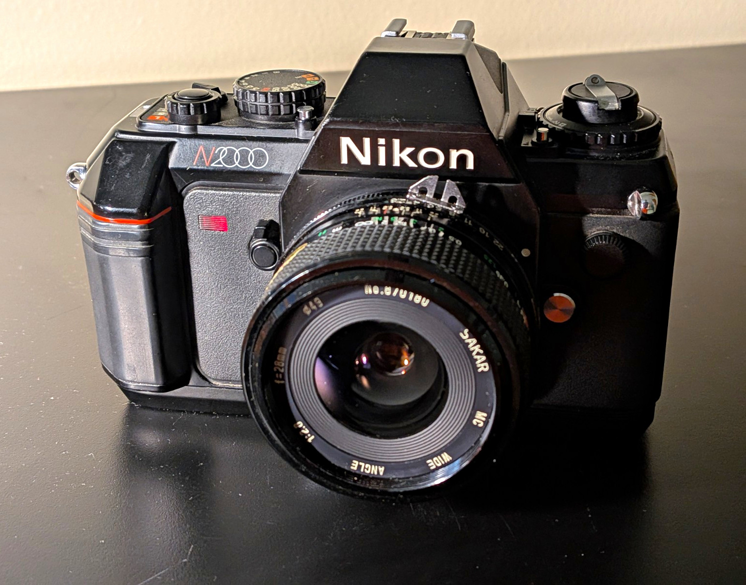 NM Nikon N2000 Black 35mm SLR Film Camera Body with 28mm Lens Included NM Nikon N2000 Black 35mm SLR Film Camera Body with 28mm Lens Included