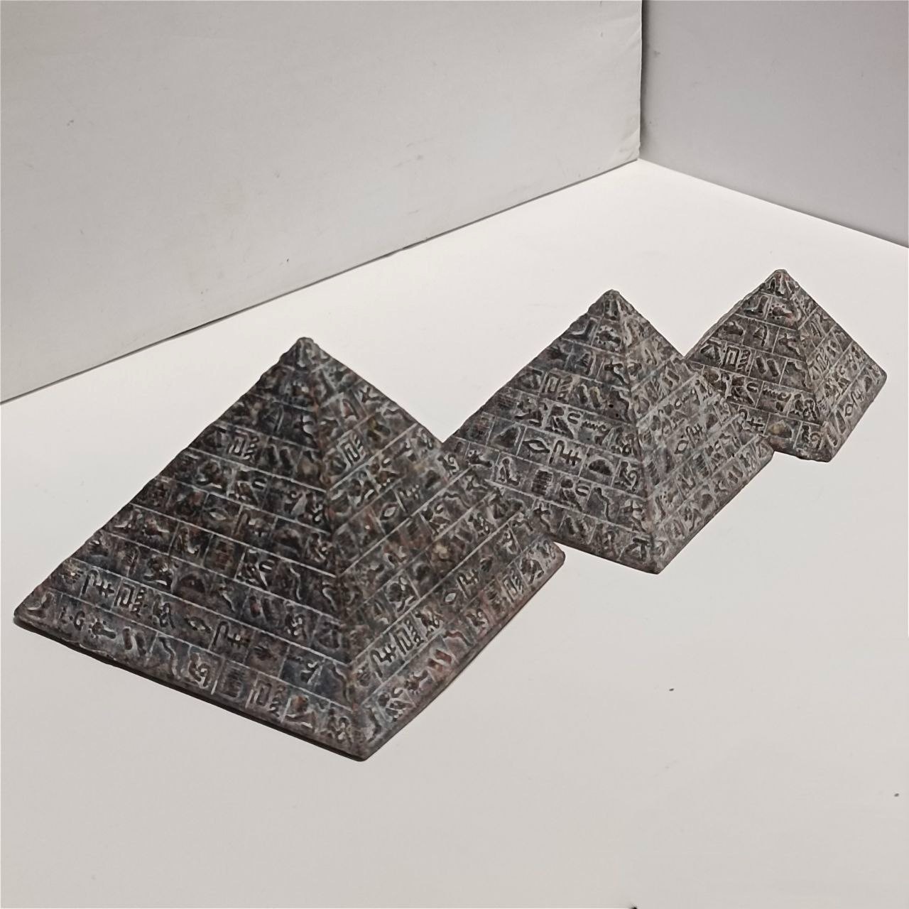 Ancient Egyptian pyramid figurines handmade stone decor hieroglyph art .