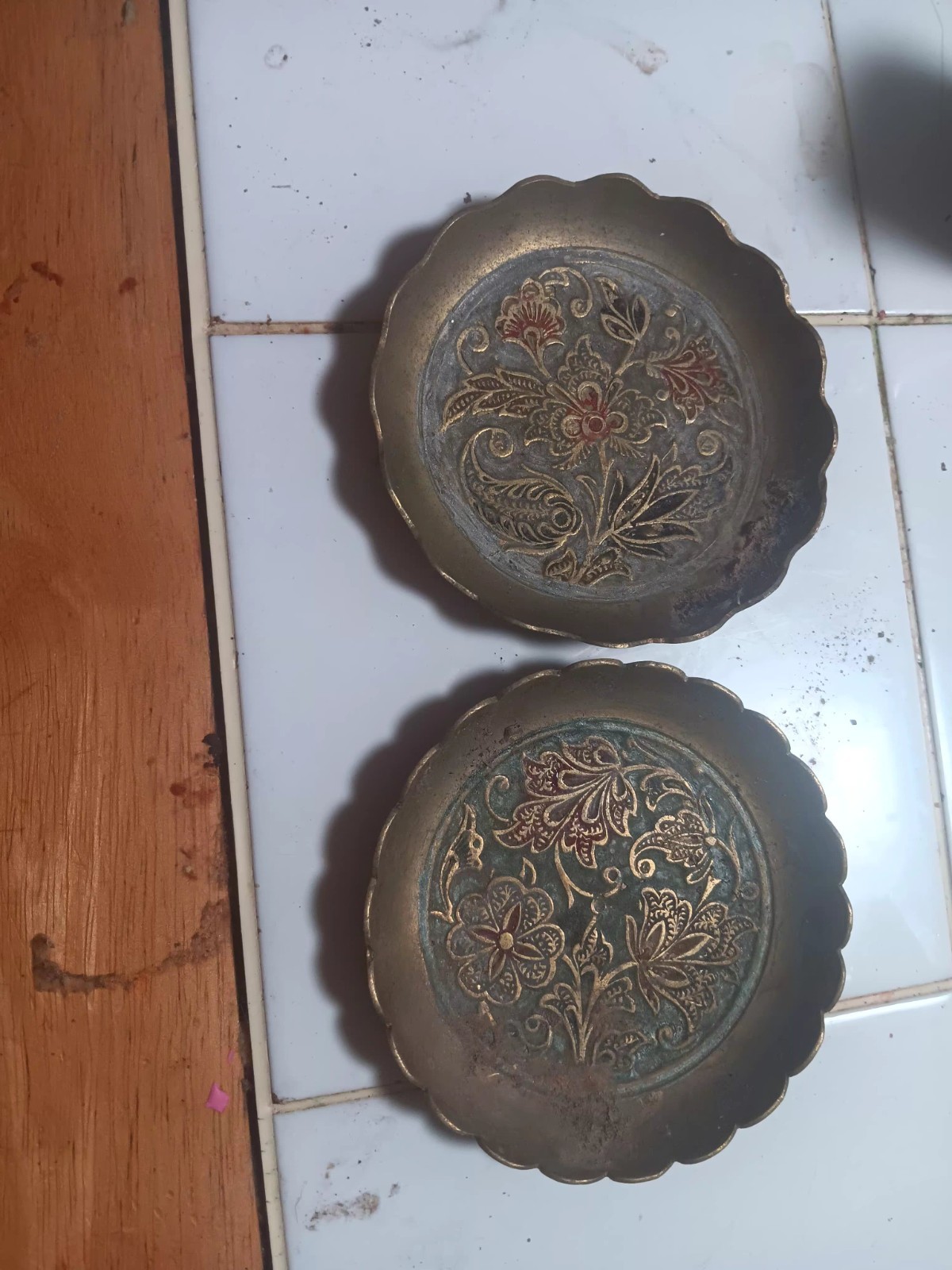 This is a vintage embossed brass plate featuring an intricate floral design This is a vintage embossed brass plate featuring an intricate floral design