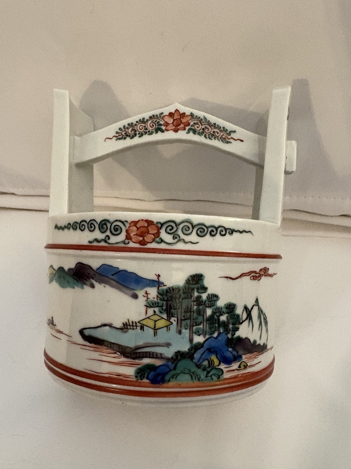 A 19th-century Japanese porcelain water pot with landscape decoration. A 19th-century Japanese porcelain water pot with landscape decoration.