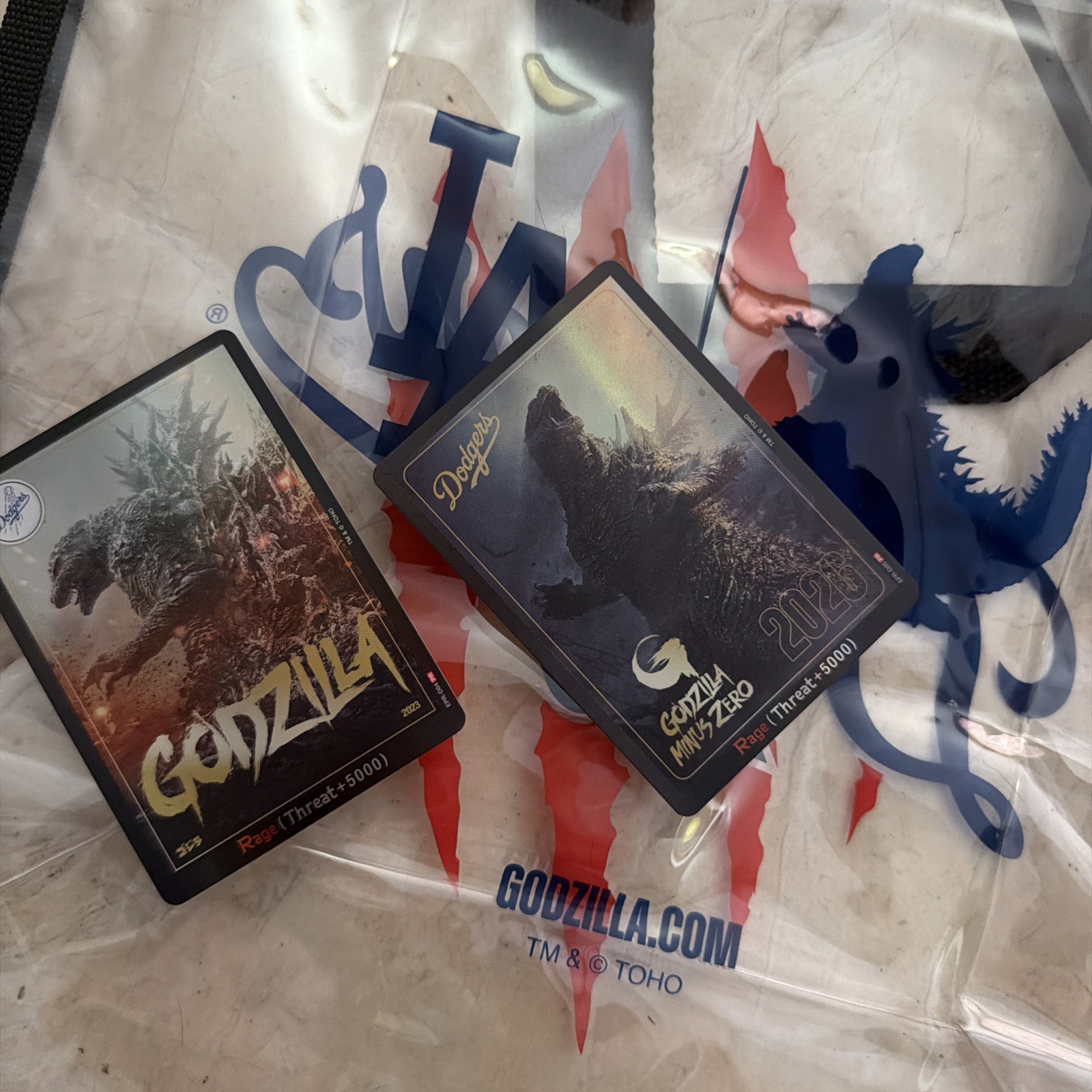 Dodgers x Godzilla Minus Zero Clear Tote + 2 Trading Cards (2023 & 2026). Dodgers x Godzilla Minus Zero Clear Tote + 2 Trading Cards (2023 & 2026).