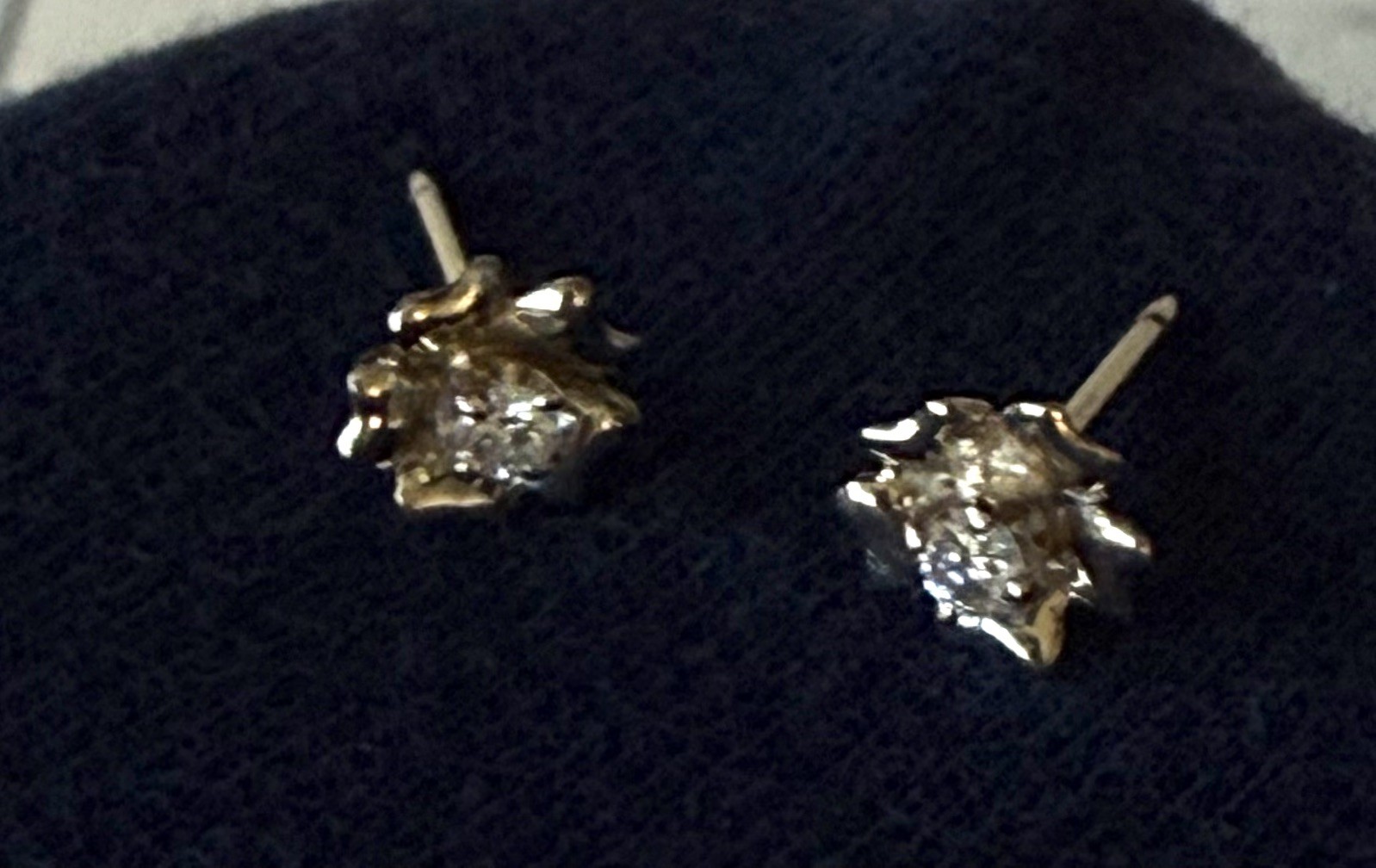 Genuine Diamond earrings mounted in a delicate buttercup setting sterling silver Genuine Diamond earrings mounted in a delicate buttercup setting sterling silver
