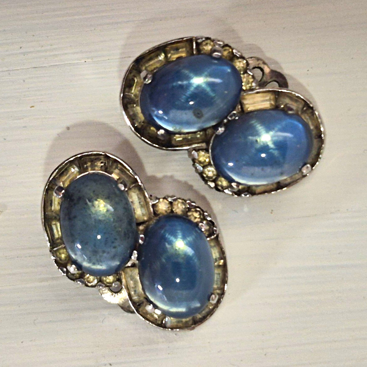 Vintage JOMAZ blue moonstone glass cabochon and rhinestone clip-on earrings. Vintage JOMAZ blue moonstone glass cabochon and rhinestone clip-on earrings.