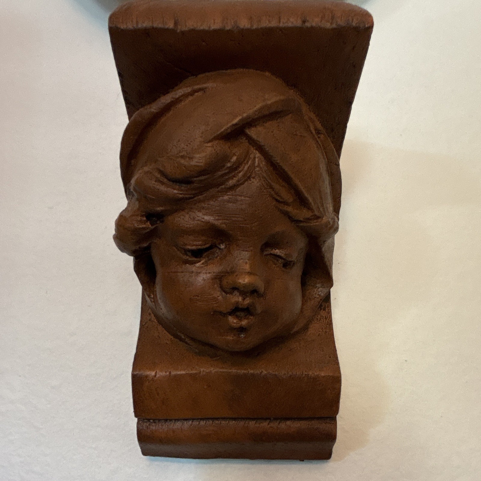 20th century French chubby faced terracotta cherub wall bracket signed “Curl”. 20th century French chubby faced terracotta cherub wall bracket signed “Curl”.