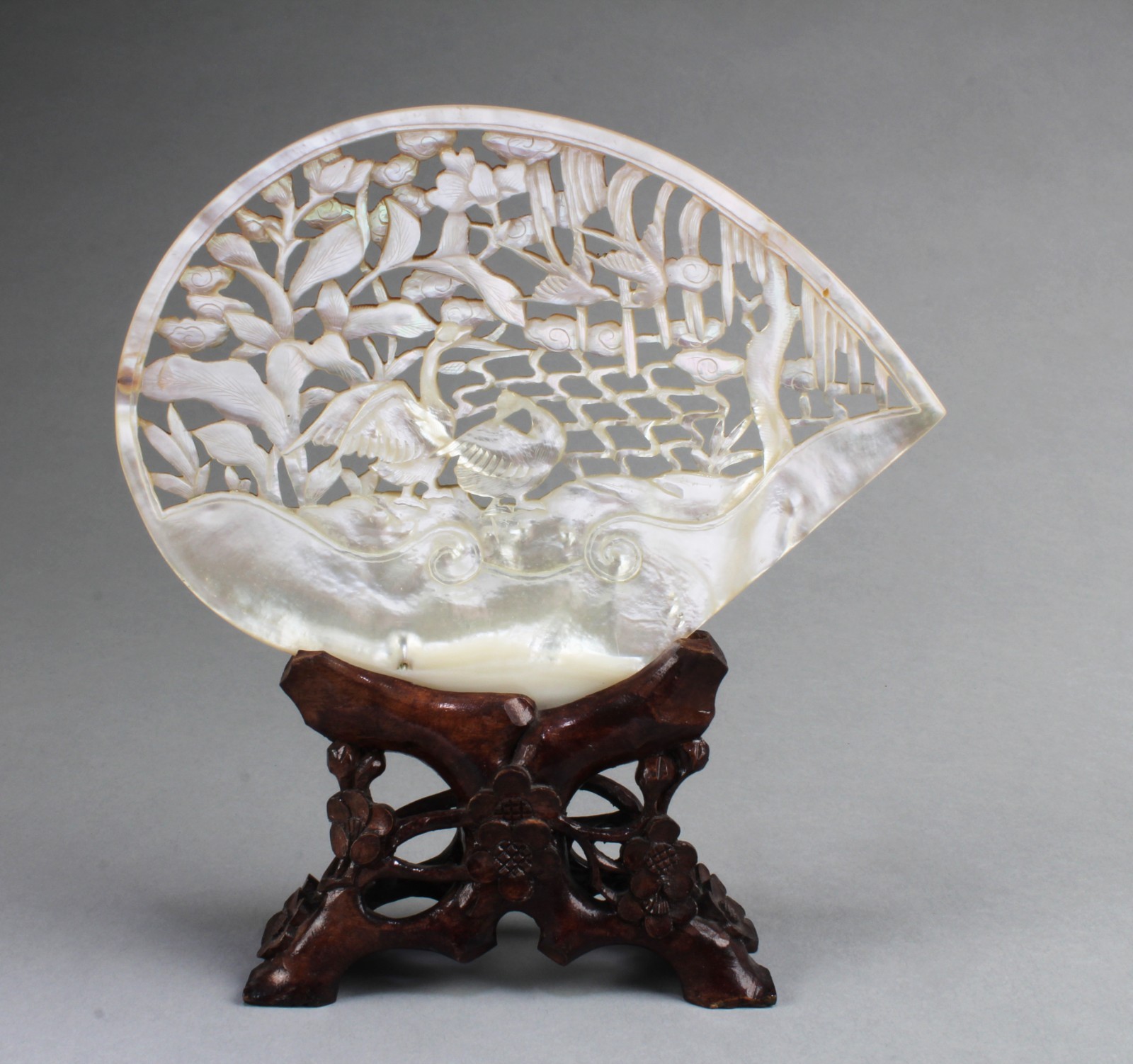 A Carved Mother-of- pearl Ornament. Comes fitted with a stand. A Carved Mother-of- pearl Ornament. Comes fitted with a stand.