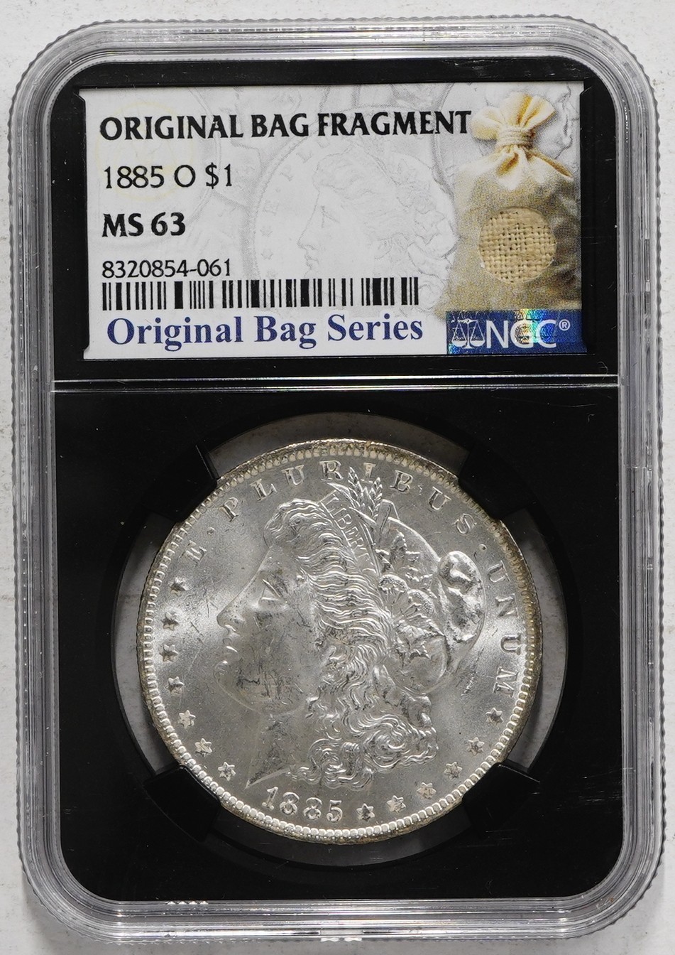 1885 O Morgan Dollar NGC MS-63 w/Original Bag Fragment