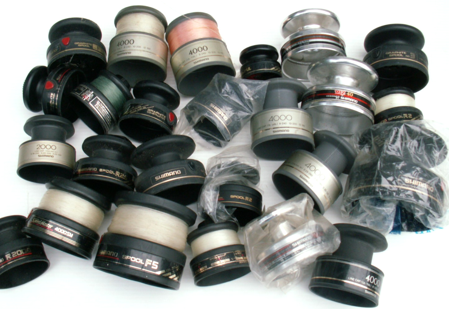 LOT OF 25 VINTAGE SHIMANO FISHING REEL SPOOLS , MANY MODELS