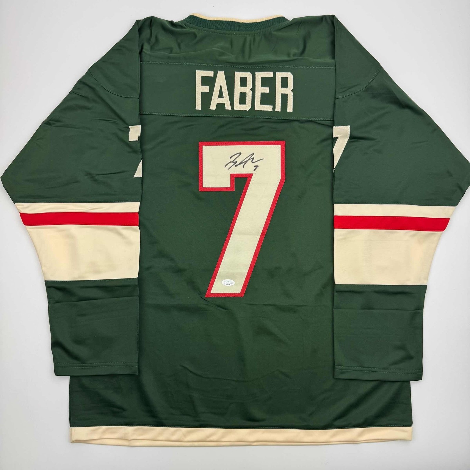Autographed/Signed Brock Faber Minnesota Green Hockey Jersey JSA COA Autographed/Signed Brock Faber Minnesota Green Hockey Jersey JSA COA