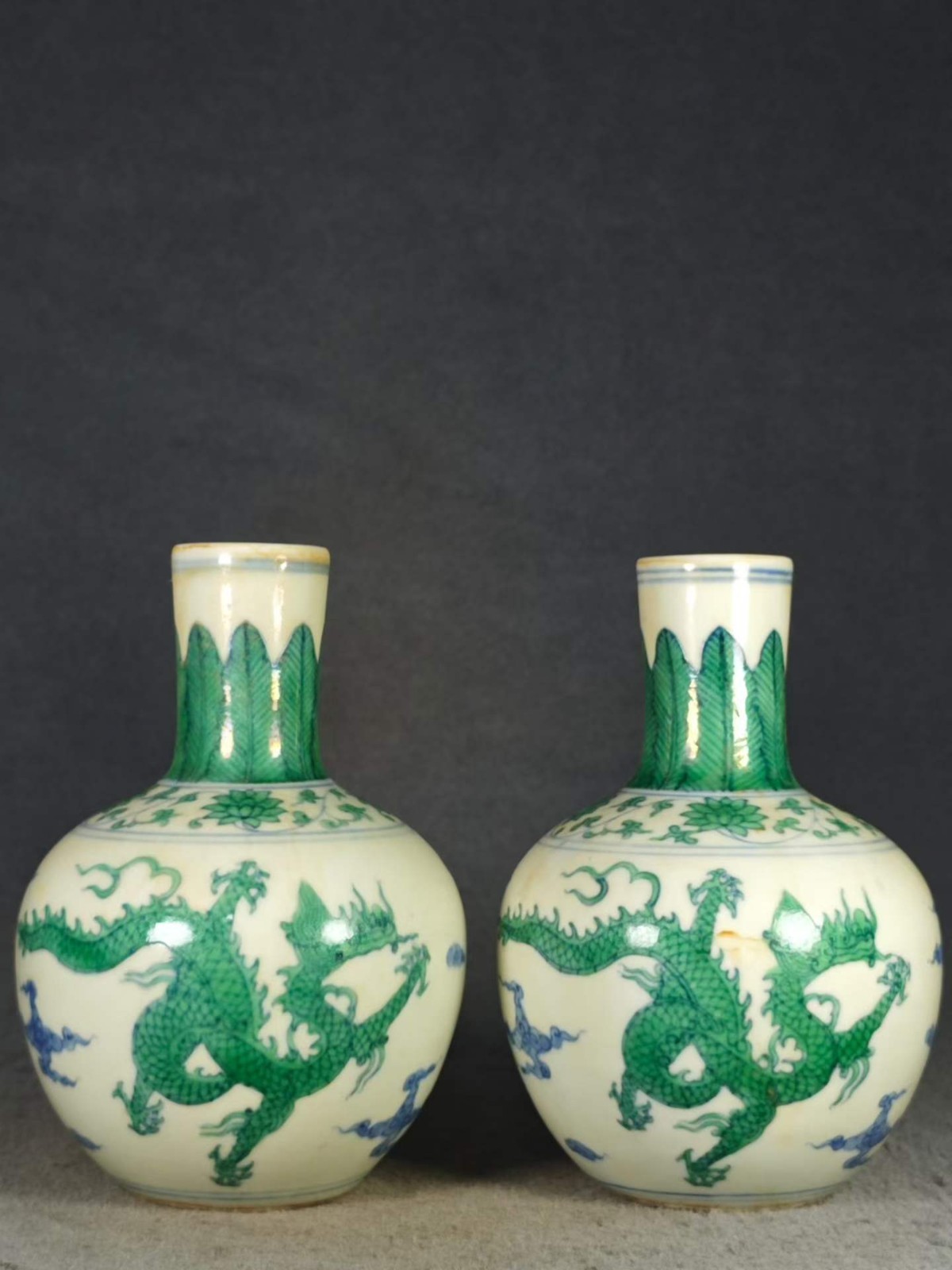 A pair of antique Chinese Chenghua-style green dragon-patterned celestial globe 