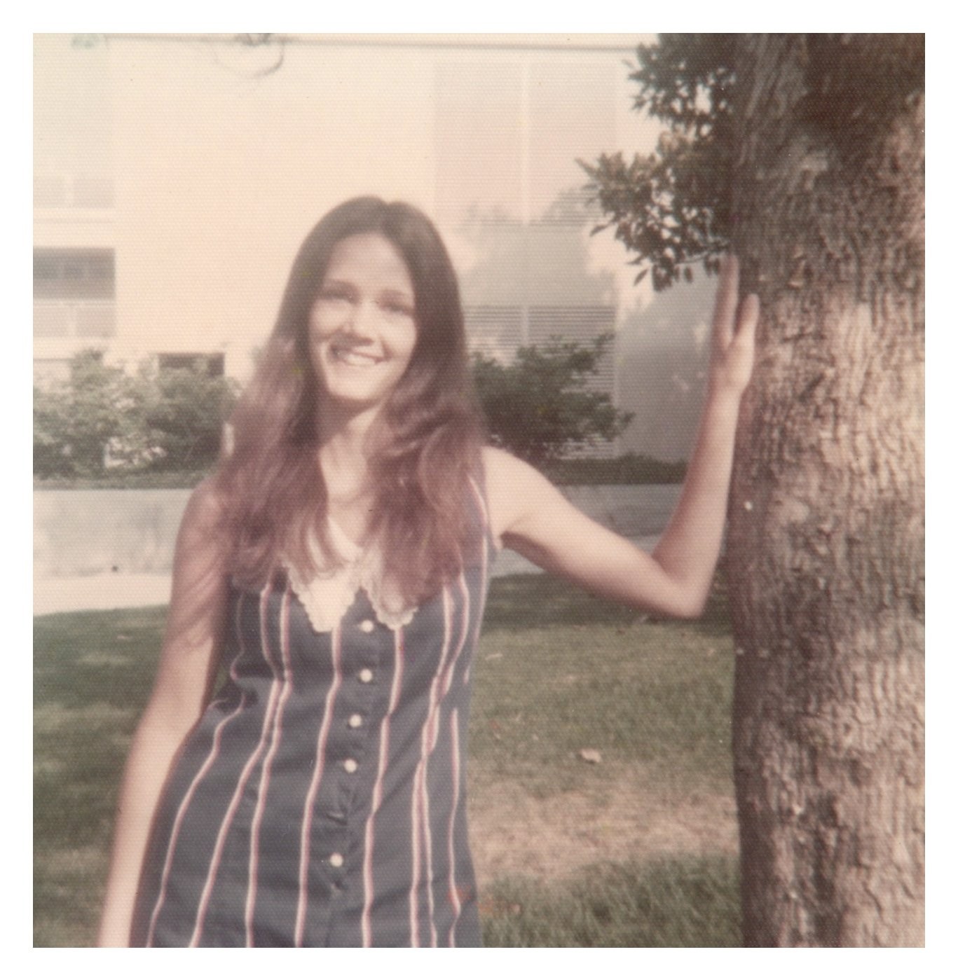 1970s Young Woman Striped Top Leaning on Tree Outdoors Vintage photo