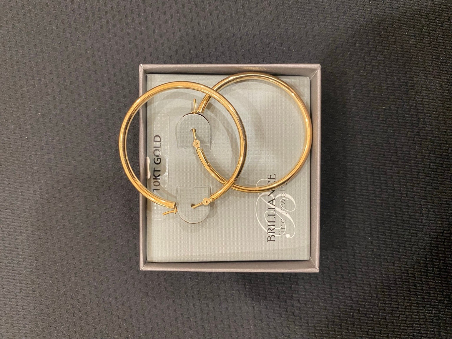 Brilliance 10K Yellow Gold Hoop Earrings 37mm x 2.3mm Hollow New in Package Brilliance 10K Yellow Gold Hoop Earrings 37mm x 2.3mm Hollow New in Package