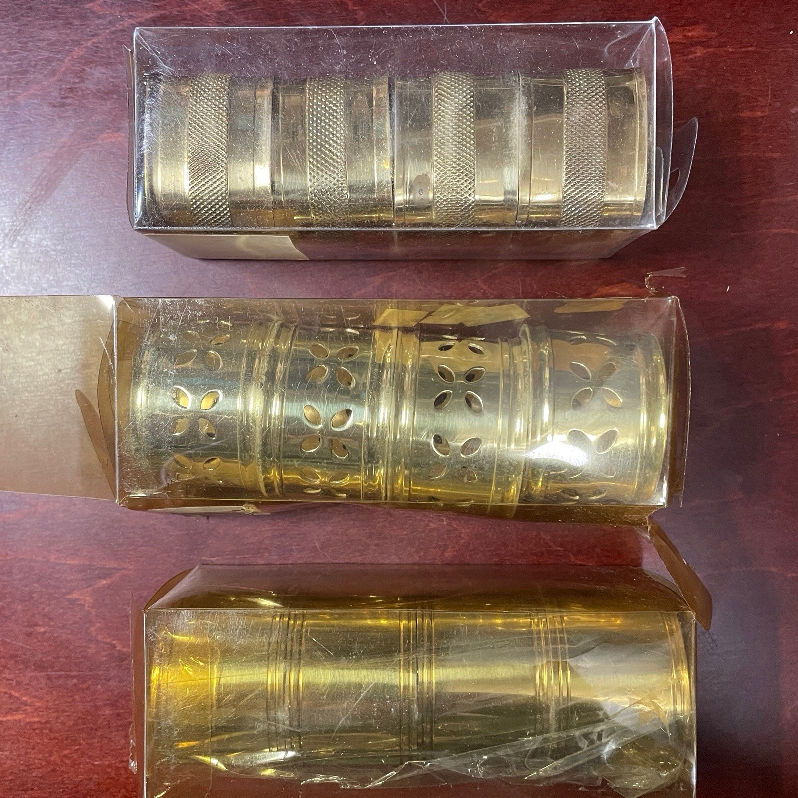Brass napkin rings - 3 sets of 4, each with a different design / made in India 