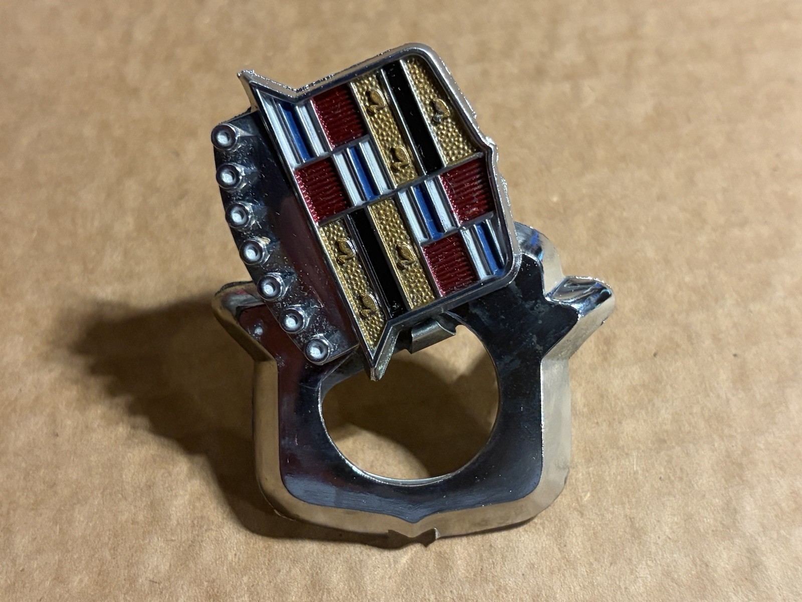 GM 9833483 Trunk Lock Flip Up Cover Emblem -- 1971-1976 Cadillac Eldorado -- NOS