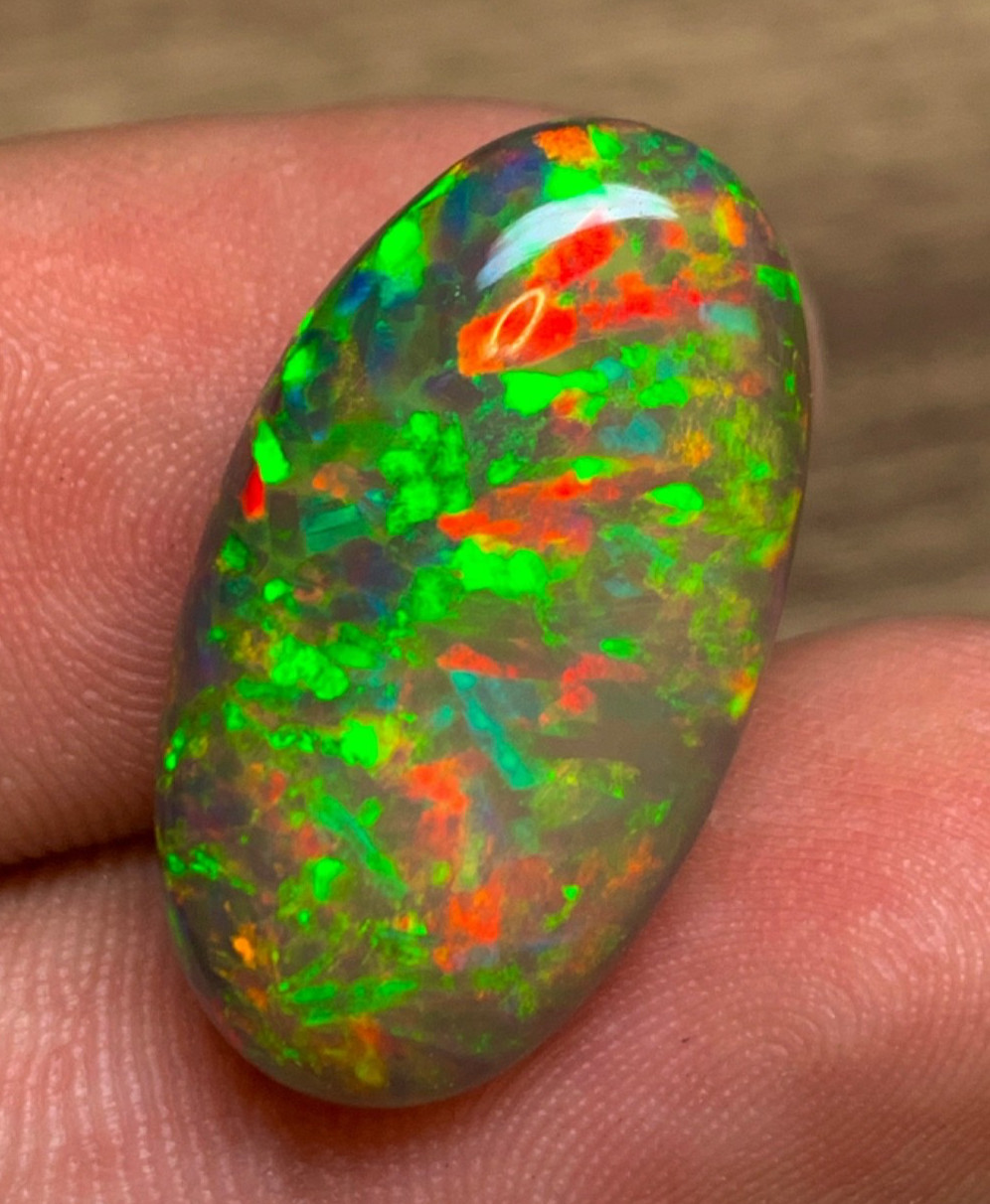 Black Ethiopian Opal 9.85 Carats Oval Cabochon having Rare Pattern Play of Color