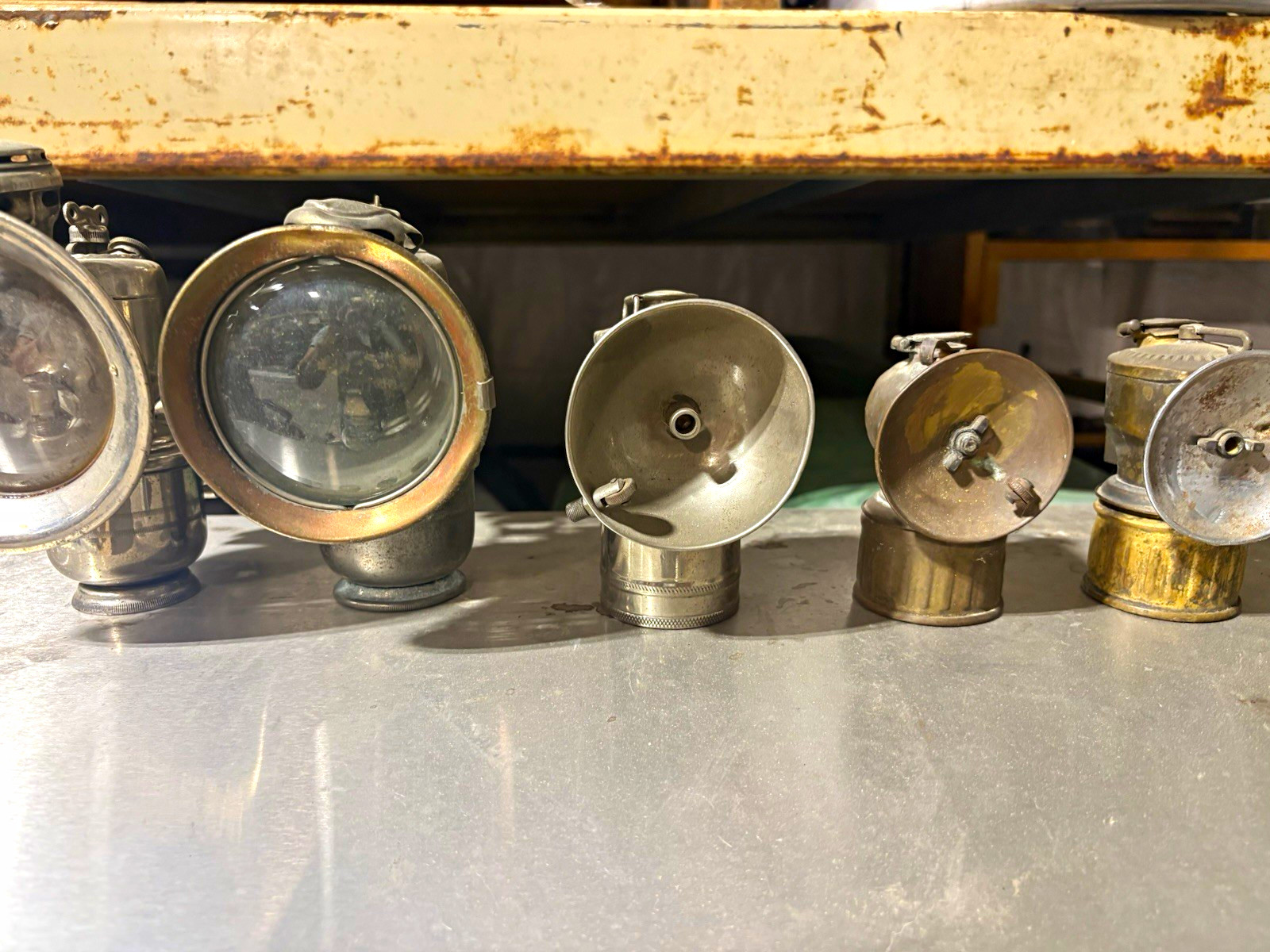 collection of 5 vintage 1910s – 1930s miner\'s carbide cap lamps.