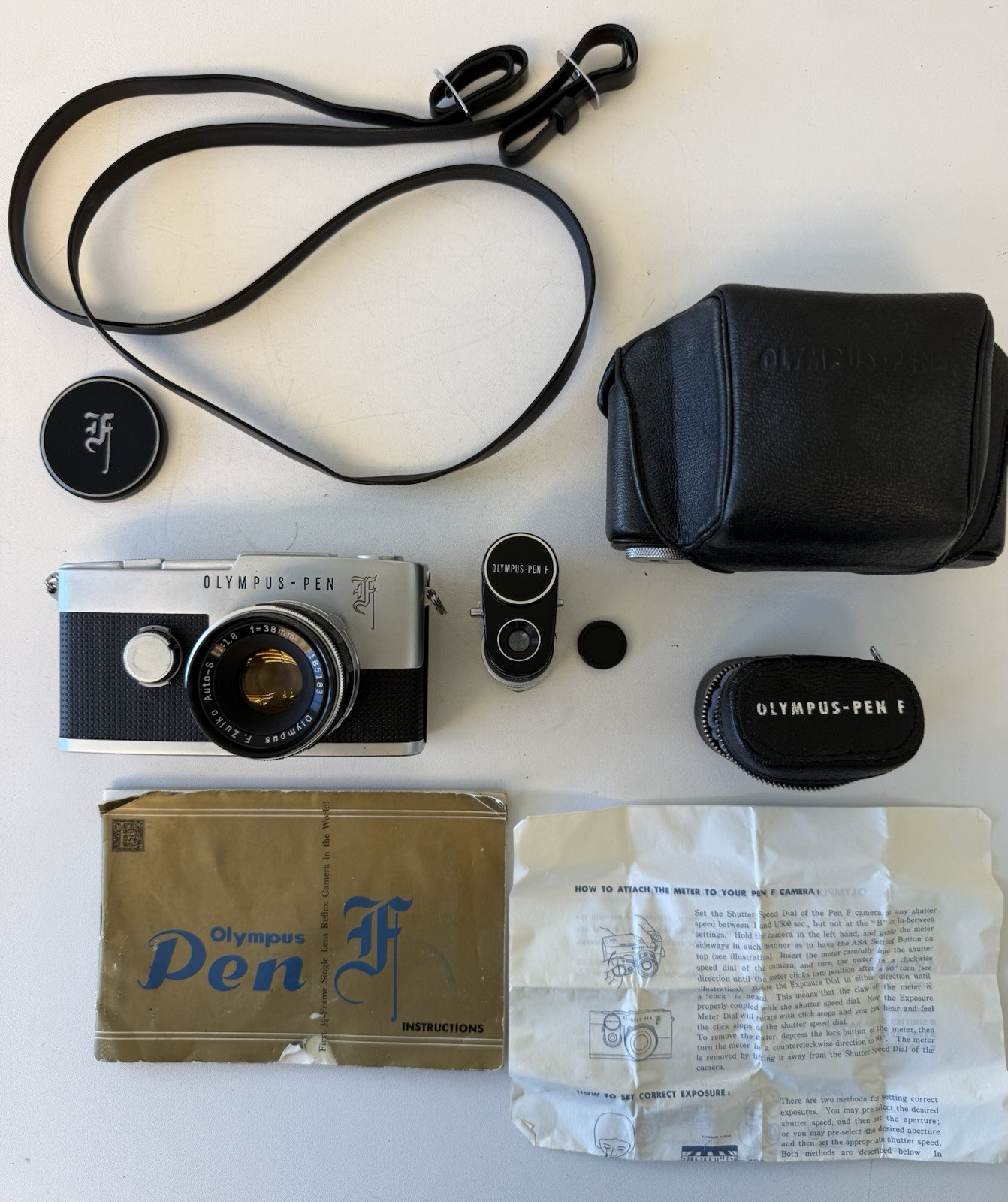 Olympus Pen F half-frame 35mm SLR film camera, light meter, strap, cases manuals