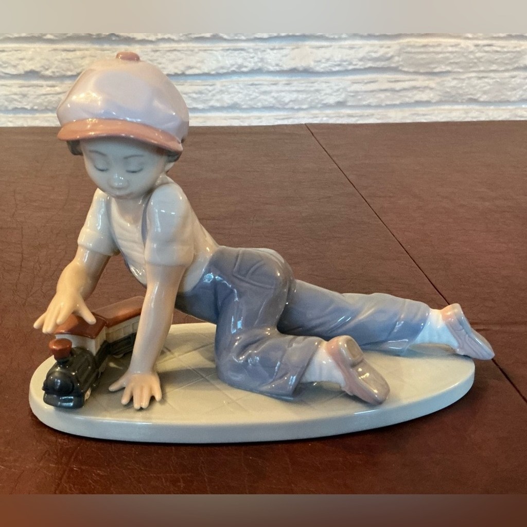 Adorable Porcelain Lladro of a Boy playing w/a Toy Train in glossy pastel colors