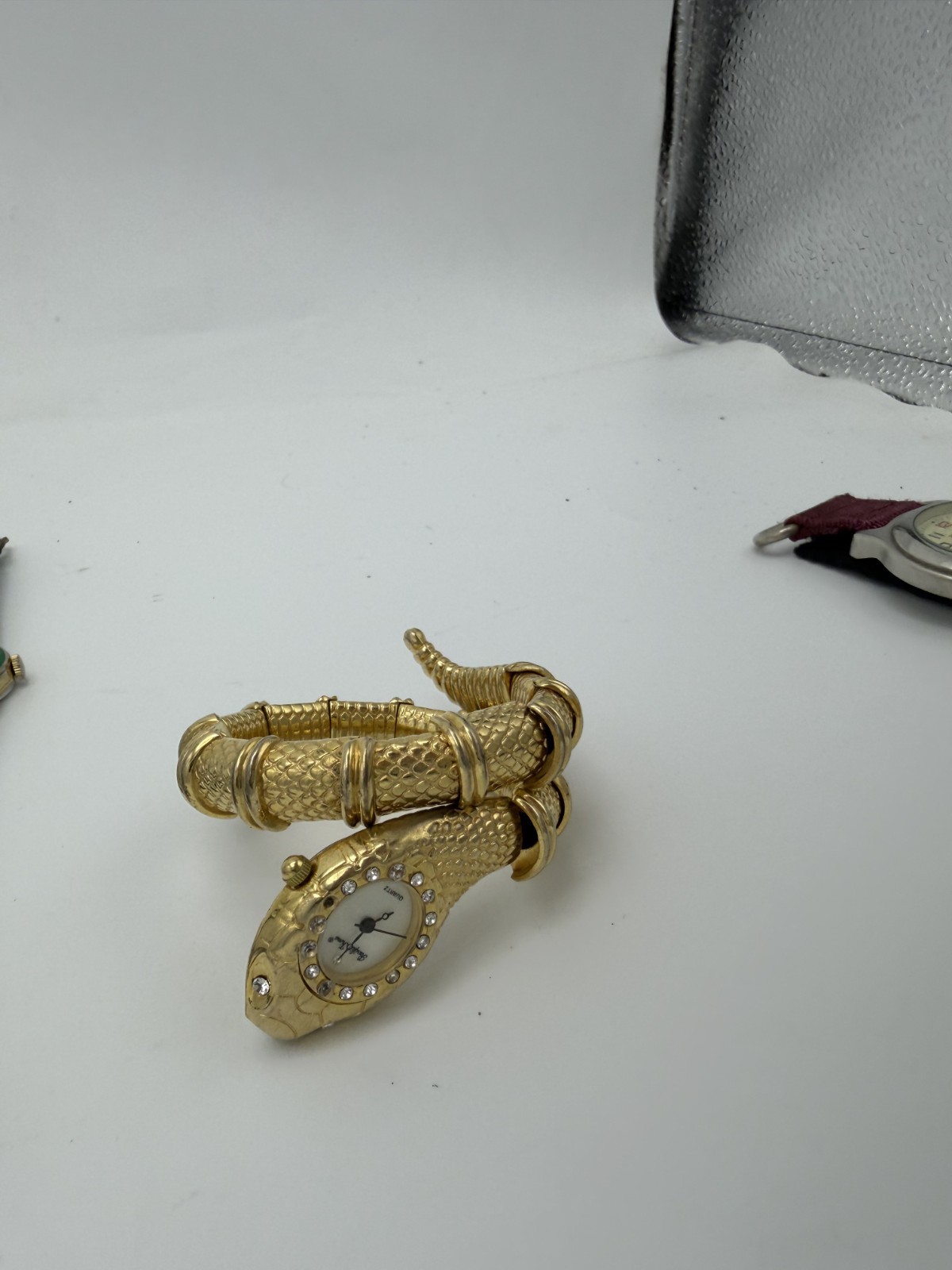 Jewelry JewelElegant vintage-inspired snake bracelet watch featuring a striking