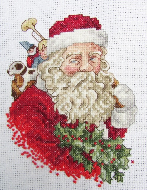 Santa with toys and holly finished cross stitch on white Aida unframed Santa with toys and holly finished cross stitch on white Aida unframed
