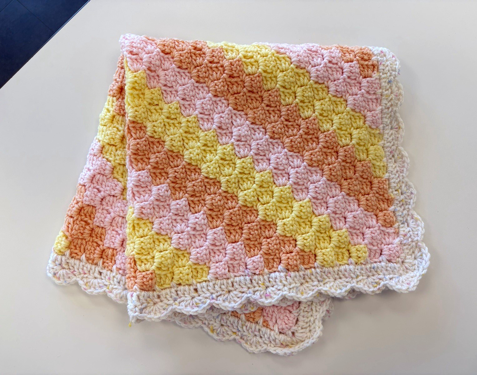 Handmade crocheted baby blanket in Pink Yellow Orange White with Scalloped Edge