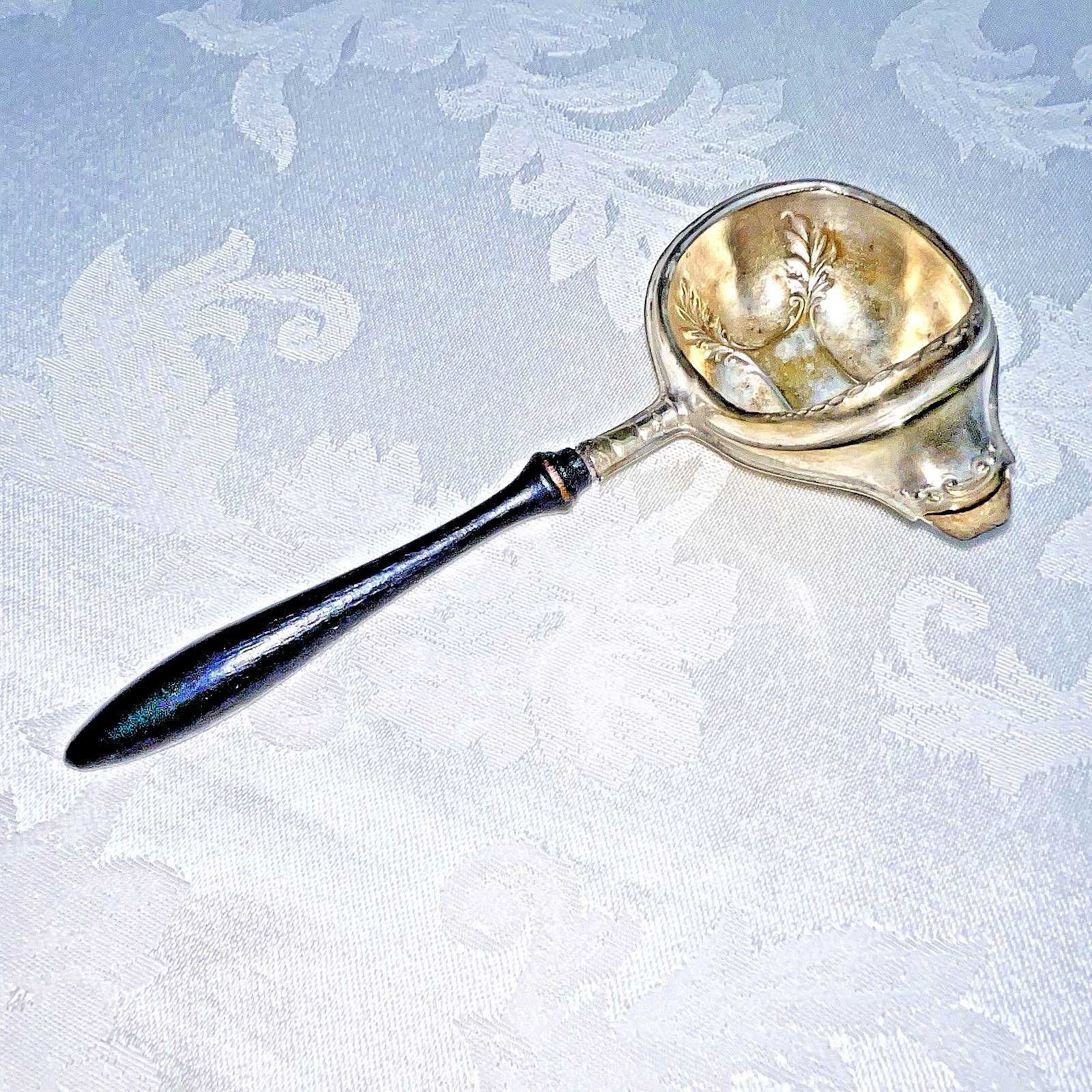 PAYE AND BAKER ANTIQUE SILVERPLATE TEA/GRAVY STRAINER WITH EBONY HANDLE