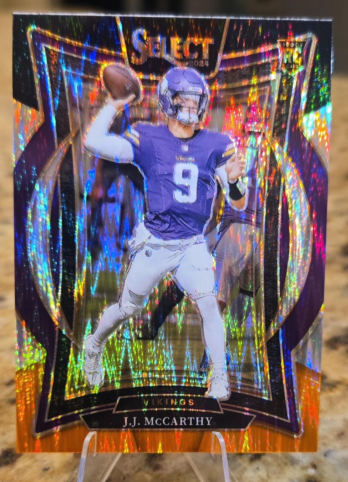 2024 Panini Select - Concourse J.J. McCarthy #24 Black & Orange Shock Prizm (RC) 2024 Panini Select - Concourse J.J. McCarthy #24 Black & Orange Shock Prizm (RC)