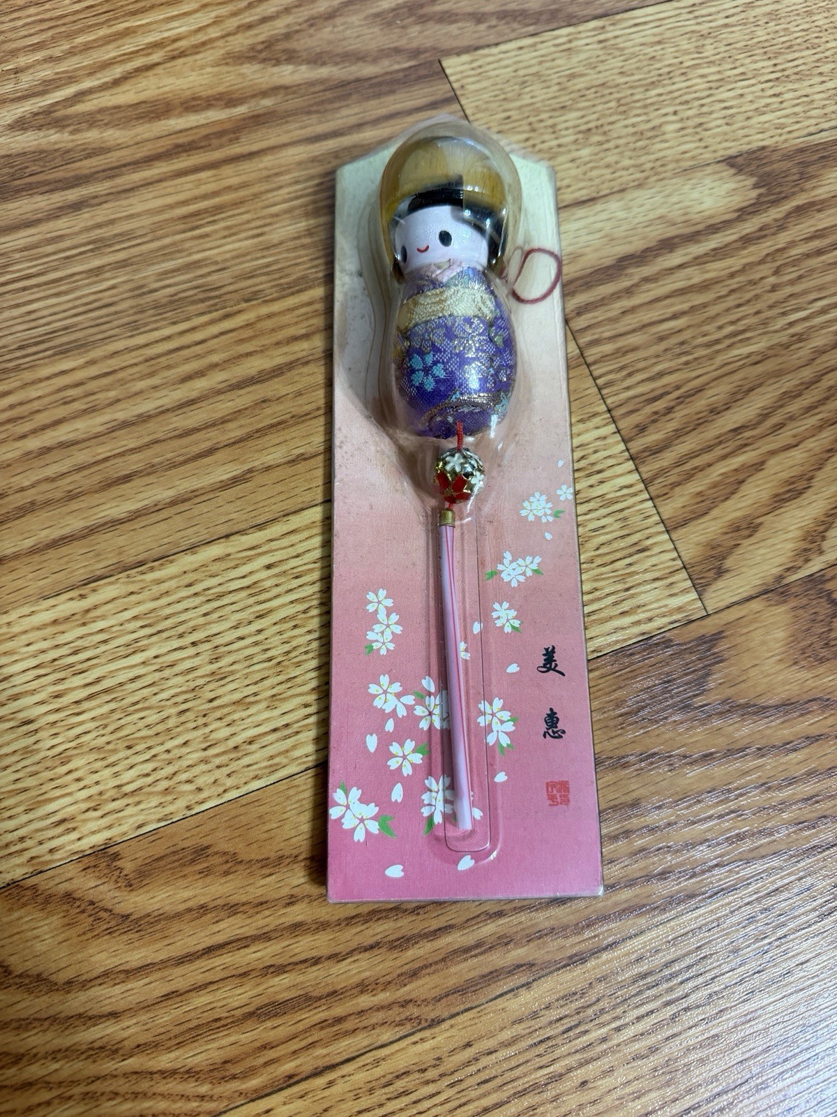 Japanese kokeshi doll souvenir featuring a floral patterned kimono in Package Japanese kokeshi doll souvenir featuring a floral patterned kimono in Package