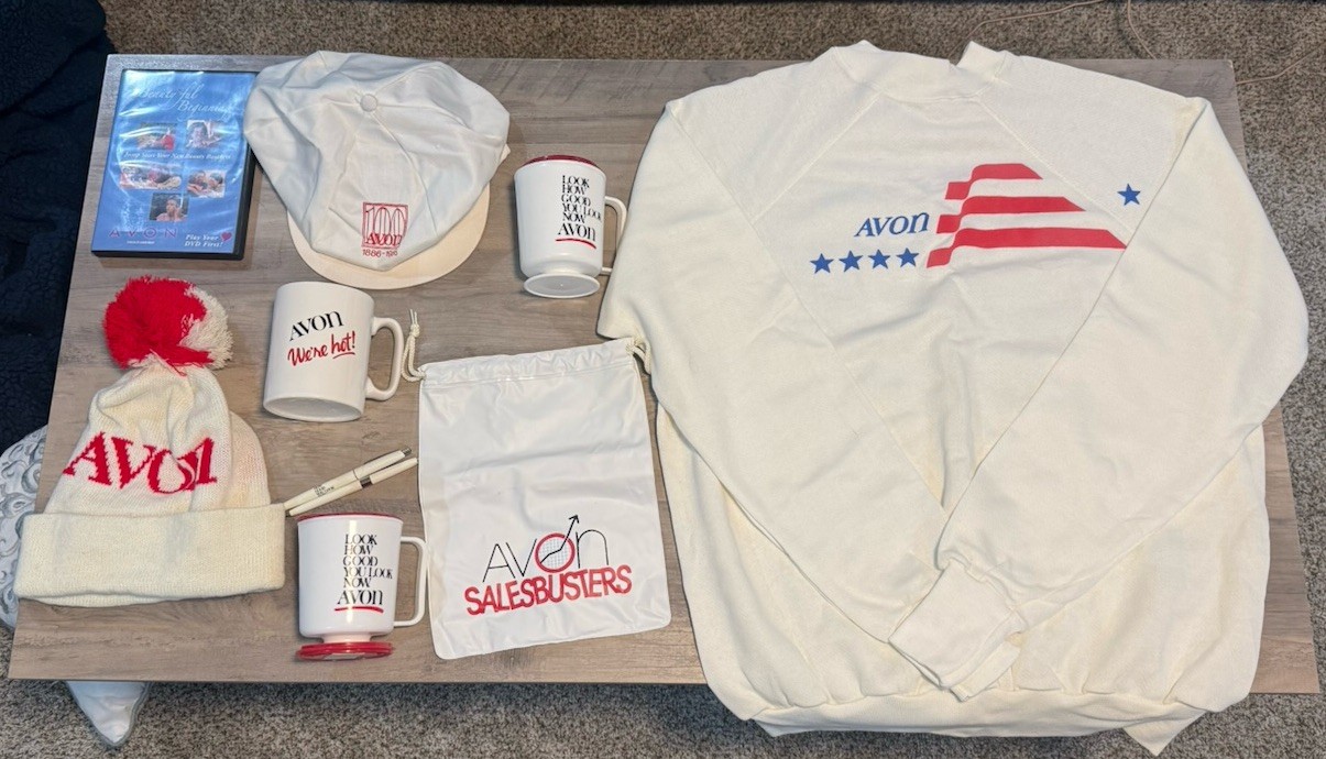 VTG Avon Memorabilia Lot. Crewneck Shirt, 2 Hats, 3 Cups, 2 Pens, Cinch Bag, DVD