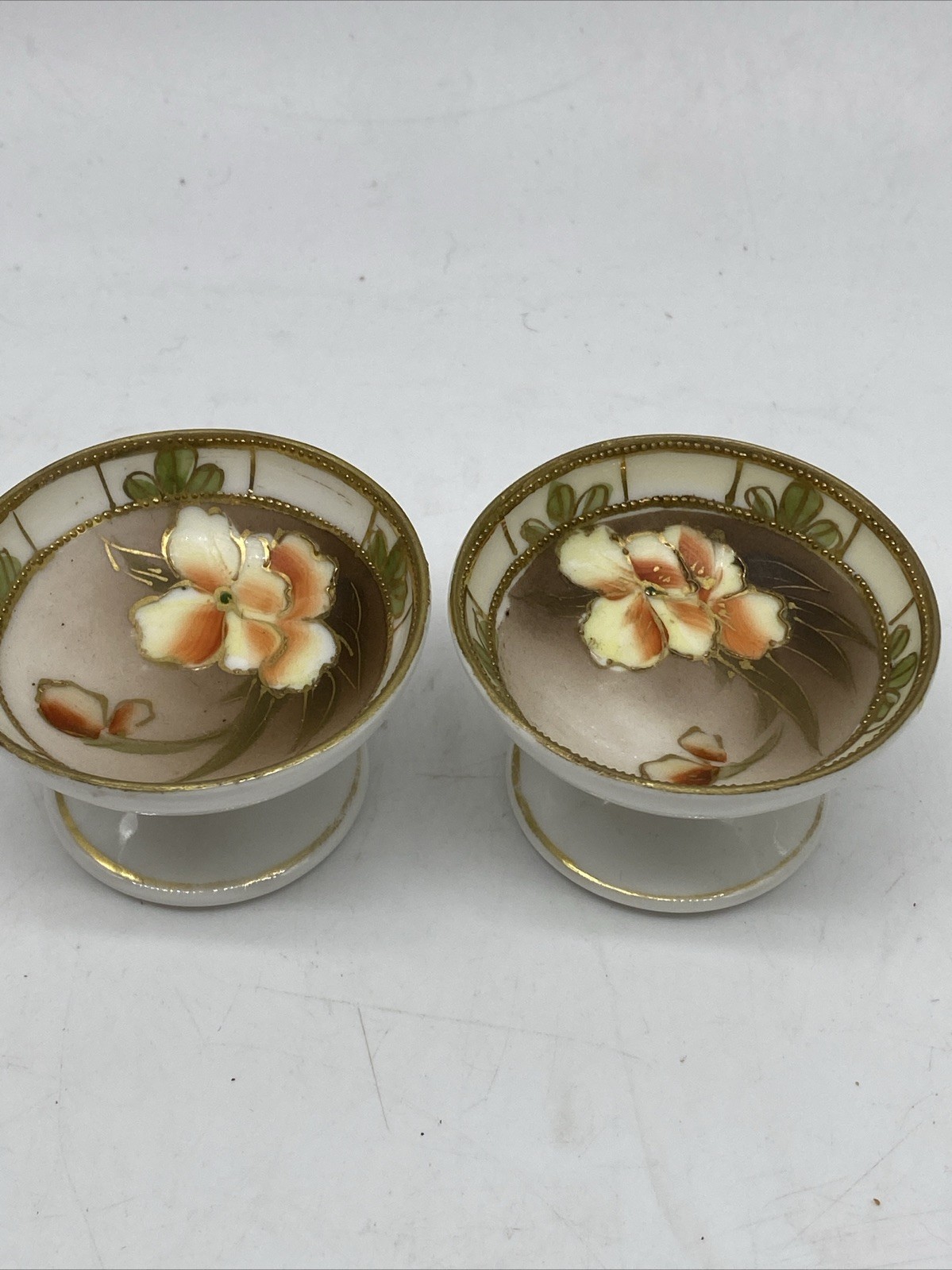 TWO VINTAGE NIPPON HAND PAINTED FLORAL FOOTED SALTS - JAPAN TWO VINTAGE NIPPON HAND PAINTED FLORAL FOOTED SALTS - JAPAN