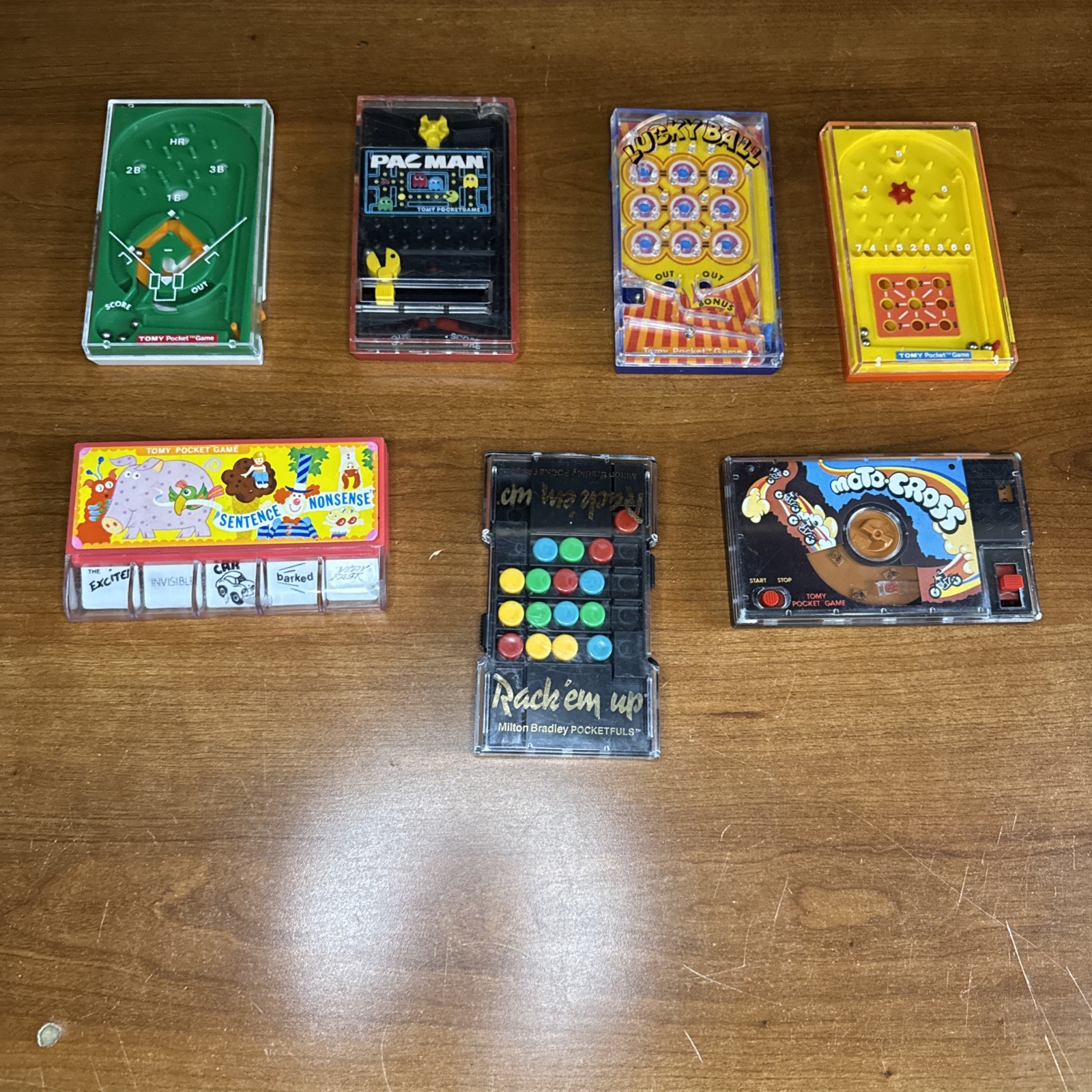 Lot Of 7 Vintage Tomy Pocket Games Milton Bradley PAC Man Rack Em Up Moto Cross