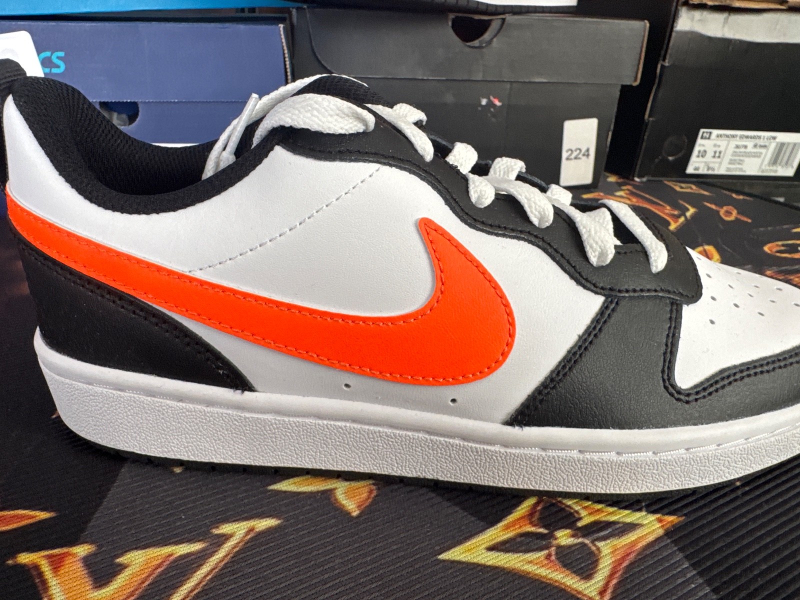 Nike Court Borough Low 2 GS, highlighted by its striking bright orange Swoosh ac
