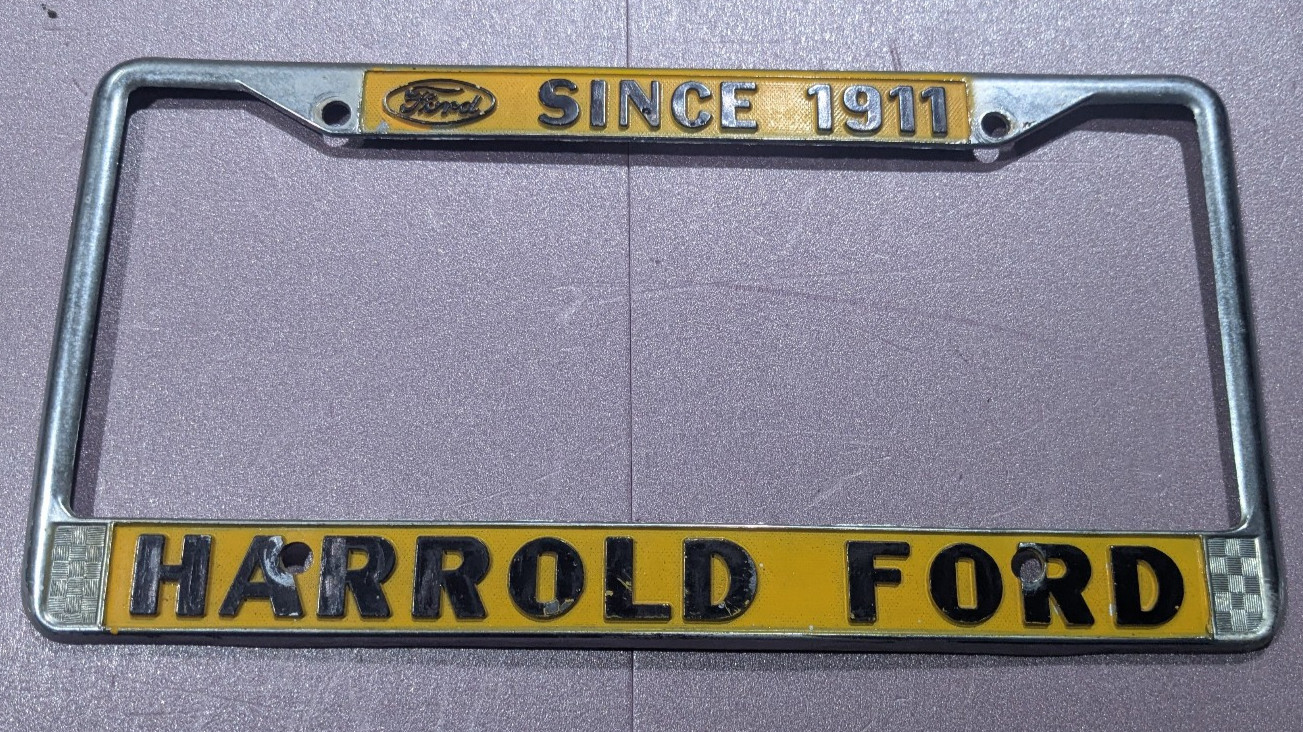 Vintage Yellow Harrold Ford Since 1911 Dealership License Plate Frame RARE Vintage Yellow Harrold Ford Since 1911 Dealership License Plate Frame RARE