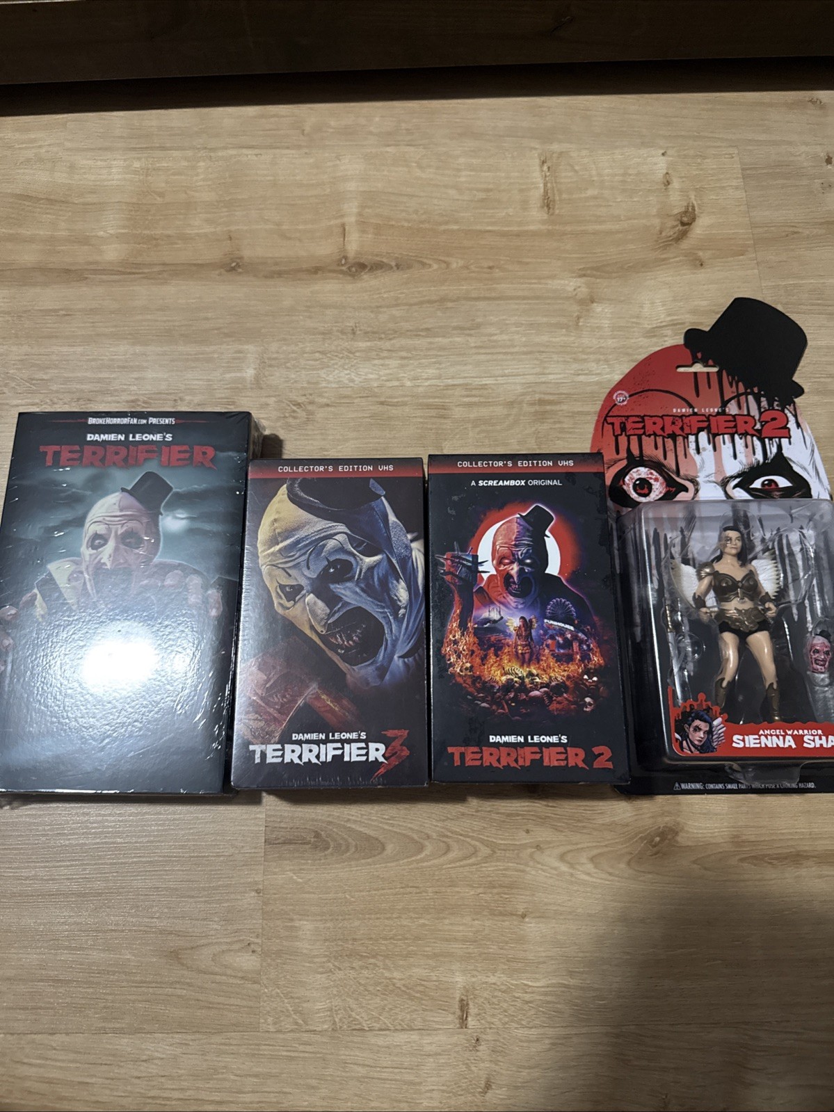 Collector's Edition VHS Of Terrfier 1, 2, & 3 With Bonus Figure