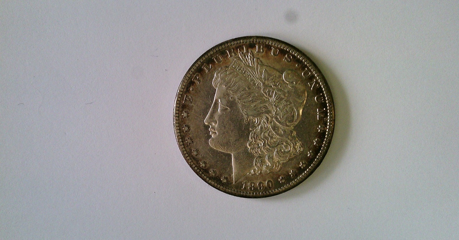1890 cc  US SILVER MORGAN DOLLAR. UNGRADED. NICE TONING. CHECK IT OUT.