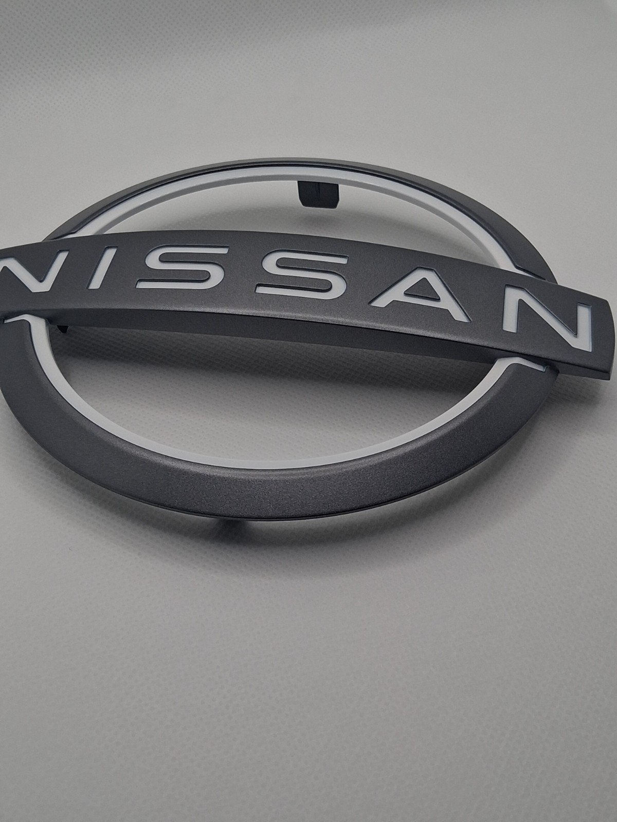 NEW OEM Nissan 2024-2025 Rogue Murano Front Grille Emblem Badge 62890-4MT0A