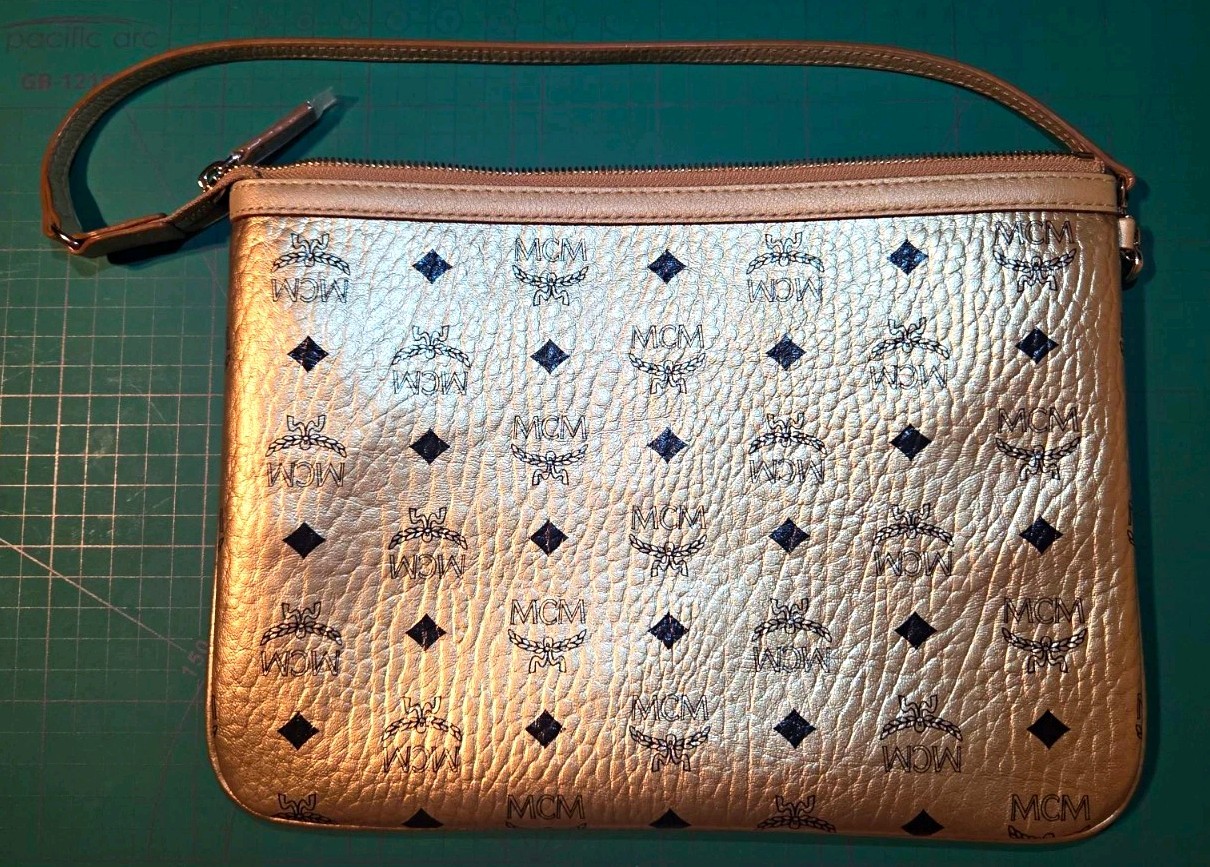 MCM Metallic Gold Monogram Zip Pouch w/ Strap 11x8 Inches MCM Metallic Gold Monogram Zip Pouch w/ Strap 11x8 Inches
