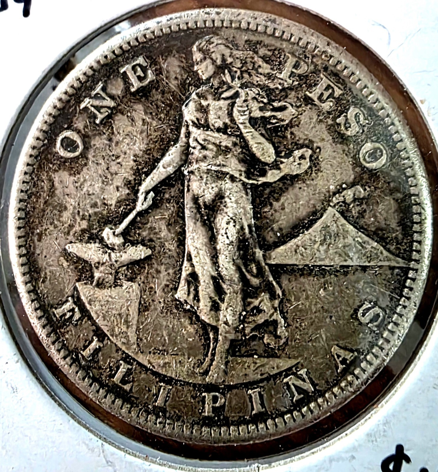 1909-S U.S.-Philippines One Peso silver coin featuring an eagle perched on a...