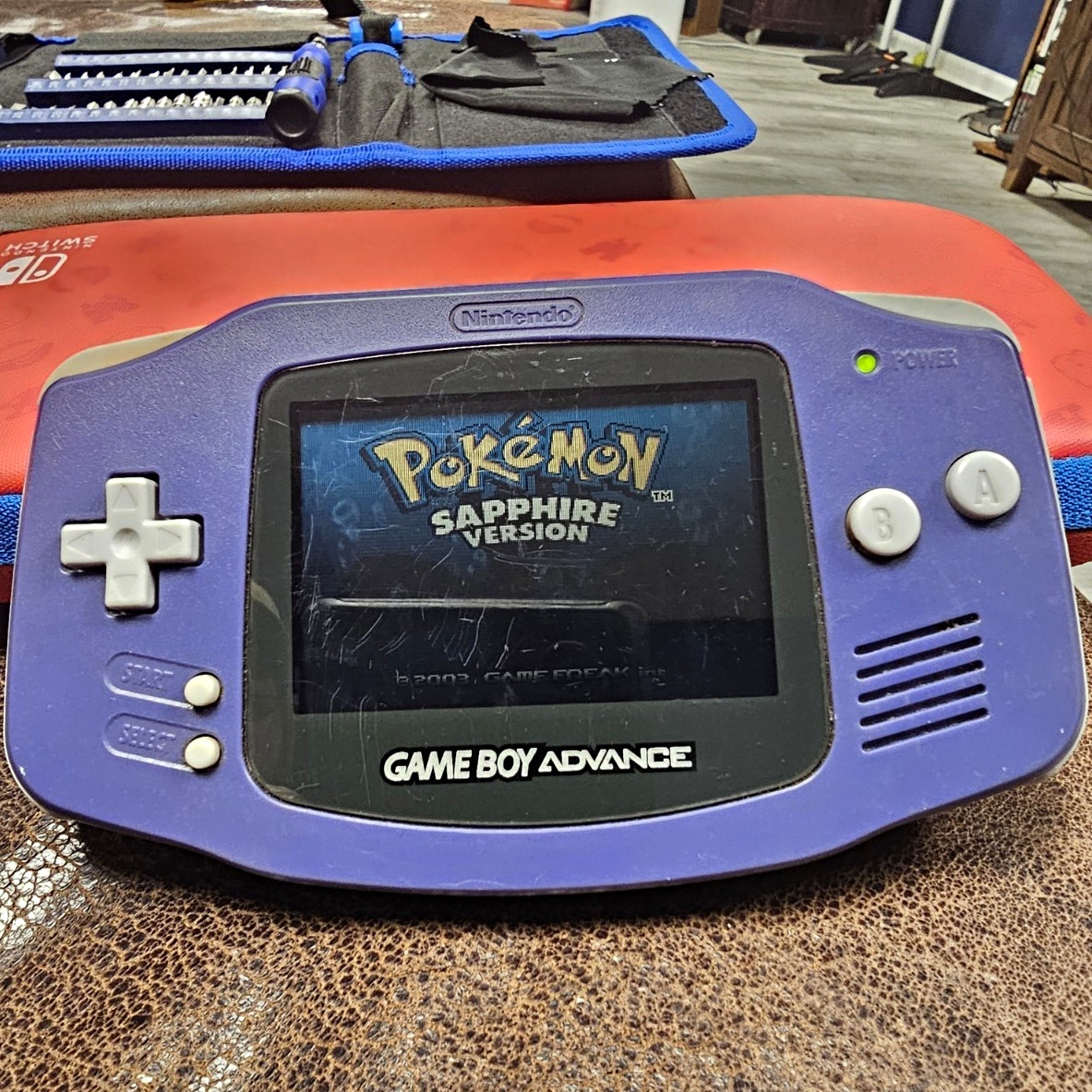 Nintendo Game Boy Advance AGB-001 Purple Handheld Region Free + Pokemon Sapphire Nintendo Game Boy Advance AGB-001 Purple Handheld Region Free + Pokemon Sapphire