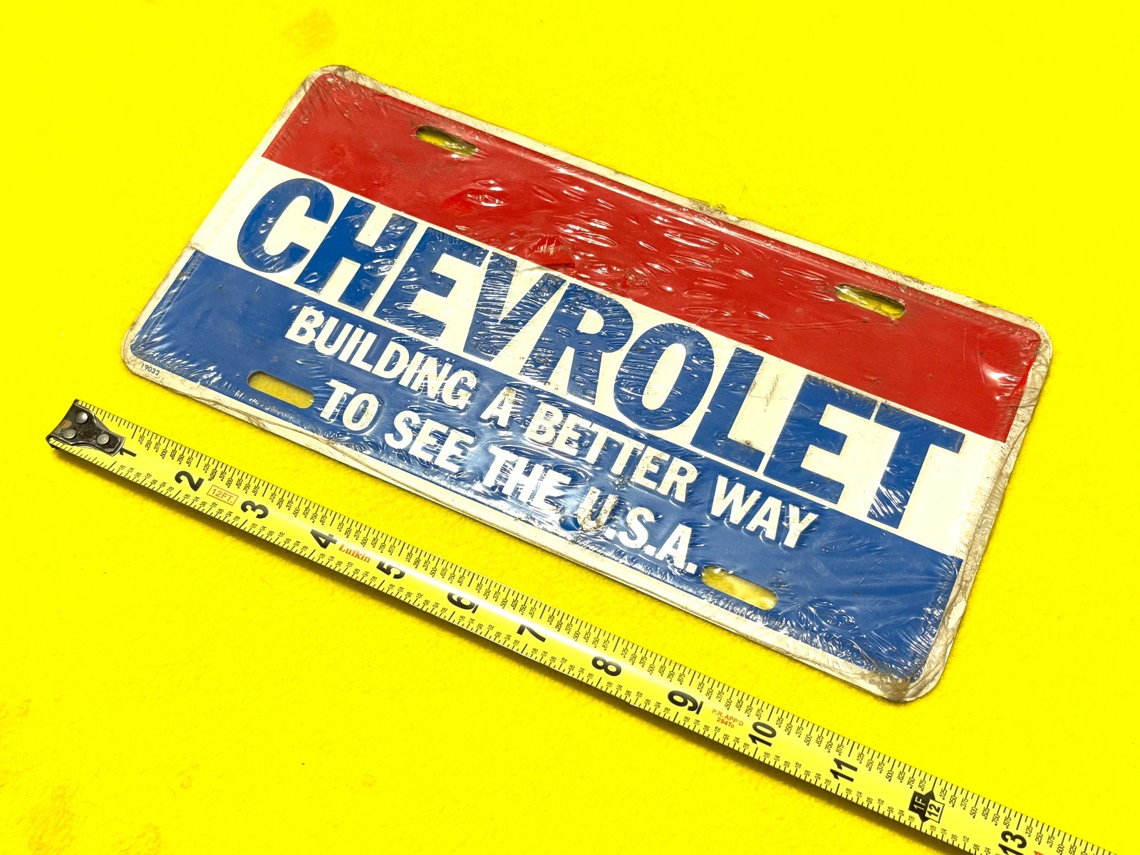 NOS Vintage CHEVROLET License Plate BUILDING A BETTER WAY TO SEE THE U.S.A.