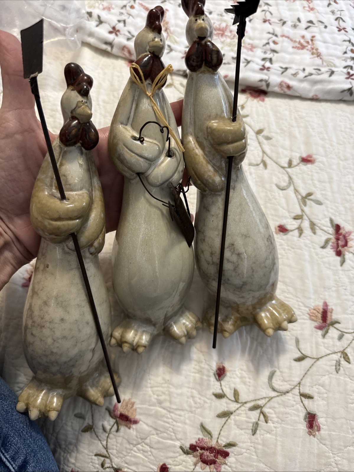 vintage anthropomorphic ceramic chickens holding gardening tools.