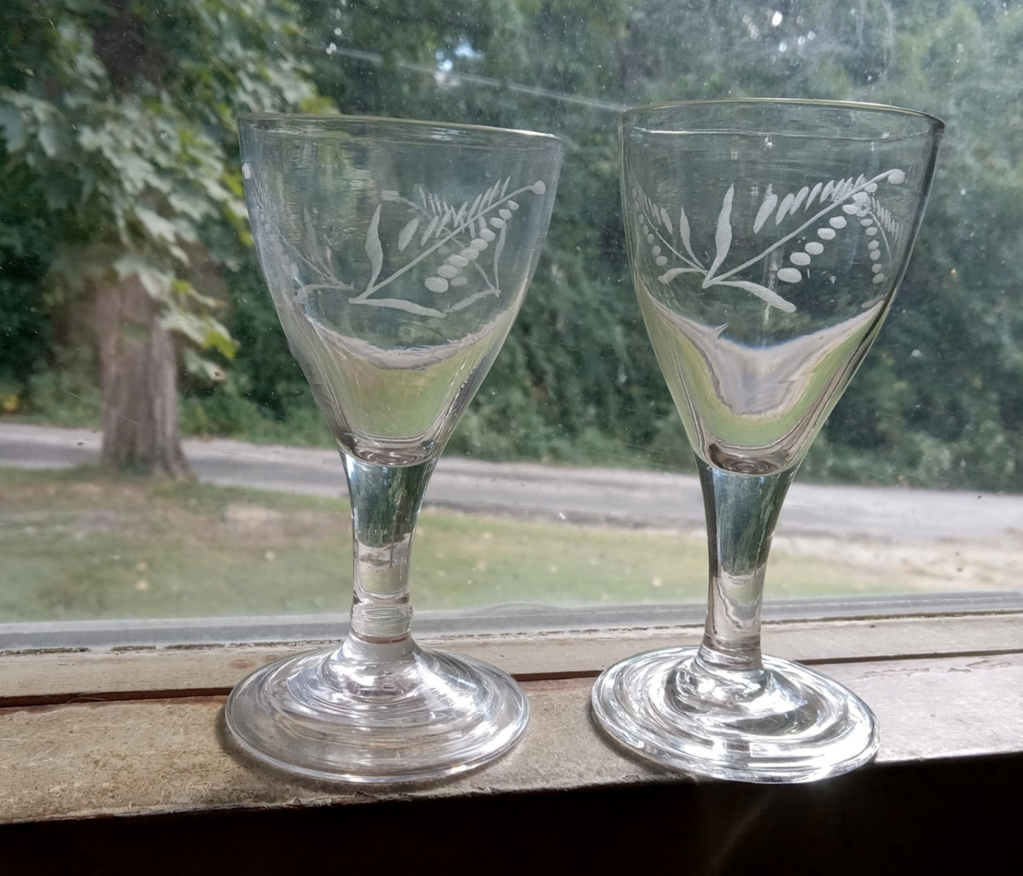 1790s EARLY FREE BLOWN PONTILED WINE GLASS PAIR WITH MATCHING ENGRAVED LEAVES 1790s EARLY FREE BLOWN PONTILED WINE GLASS PAIR WITH MATCHING ENGRAVED LEAVES