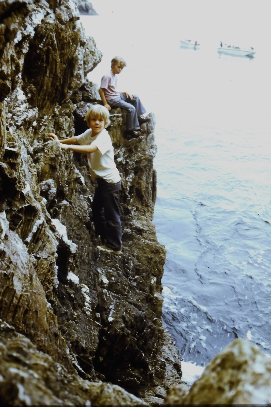 c1970's Kodachrome 35mm Slide, Boy Climbing Rocky Cliff Ocean Water blue
