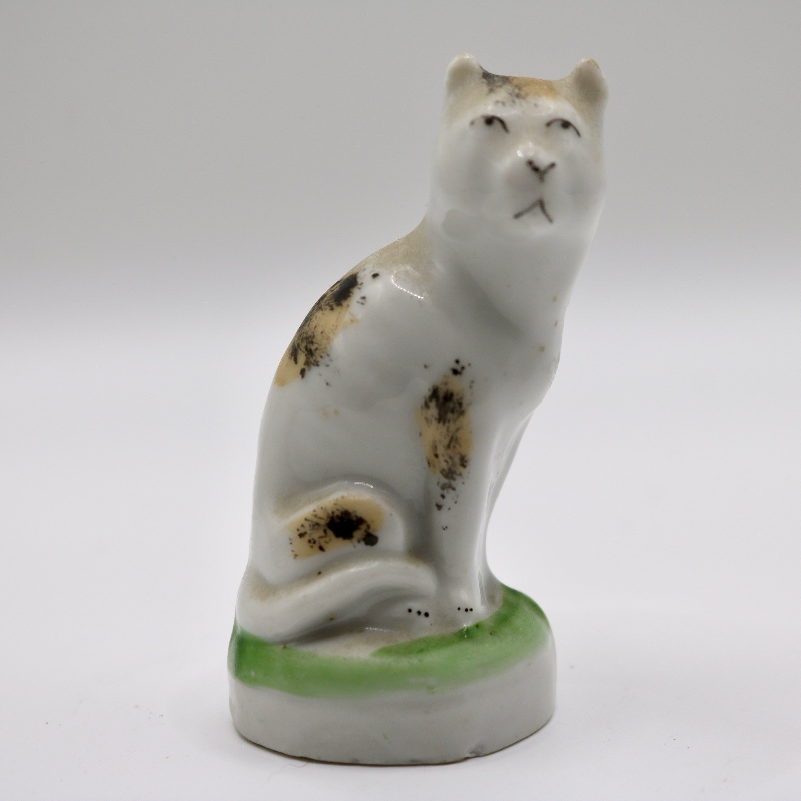 Antique Staffordshire Ceramic Cat Figurine Calico Seated Green Base 19thC