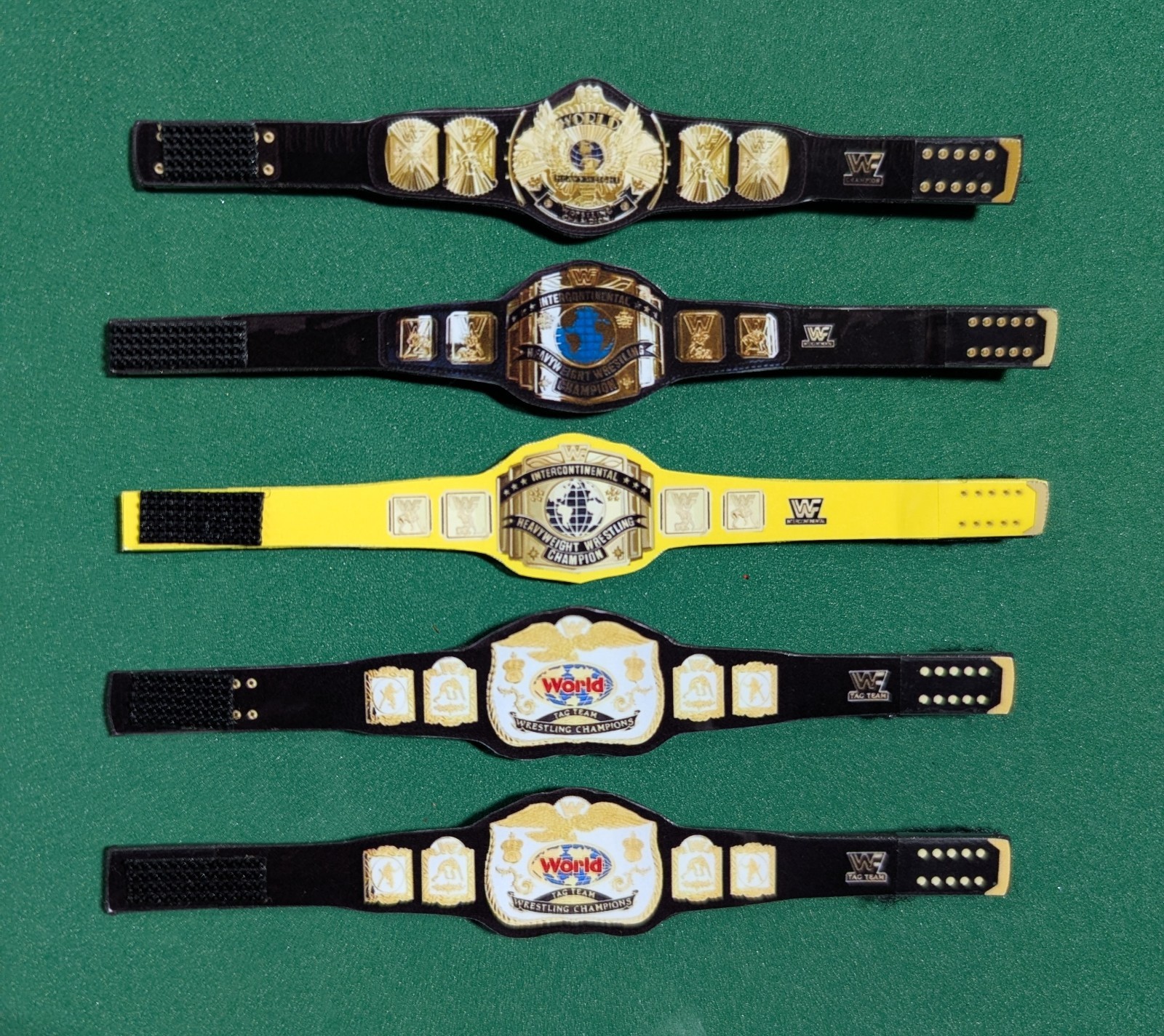 5 Custom WWF WWE 90\'s Era Hasbro Retro Belts (figures not included) 5 Custom WWF WWE 90\'s Era Hasbro Retro Belts (figures not included)