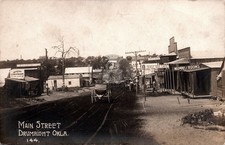 Drumright OK Main Street Busy Business Dist. Signs Wagons RPPC Postcard COPY picture