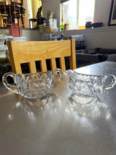 Vintage clear glass creamer and open sugar bowl set with an etched flora design picture