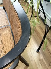 Vintage bench black wood natural woven cane seat and back with black armrests picture
